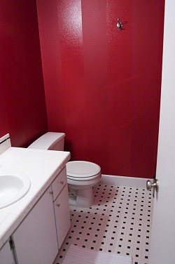 DIY striped bathroom walls in shades of red. Photo by Sayward Rebhal.