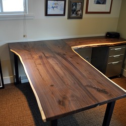 A custom native edge wood desk by the author.