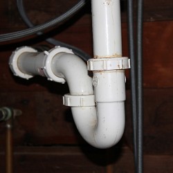 A U-bend (AKA P-trap) under a kitchen sink. (Photo by s.e. smith)