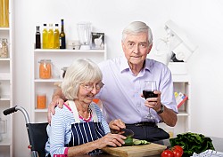 A couple prepares food in a wheel-chair accessible kitchen. (Photo: lostinbids/istockphoto.com)