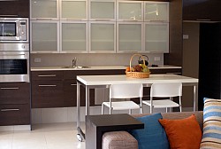 A wall oven, undermount sink, and vertical storage make the most of this small kitchen. (Lighthousebay/istockphoto.com)