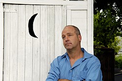 A man waits for the outhouse. Maybe he should have brought his mobile toilet. Photo: twilightproductions/istockphoto.com.
