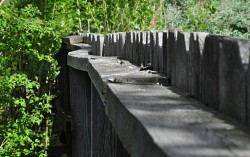 A wood fence is only as strong as its posts. Anchor posts properly in concrete, never directly in the soil. (Photo: Kevin Stevens)