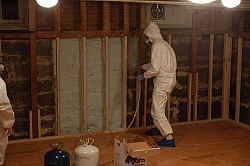 A worker sprays foam insulation. (ilovebutter/Flickr)