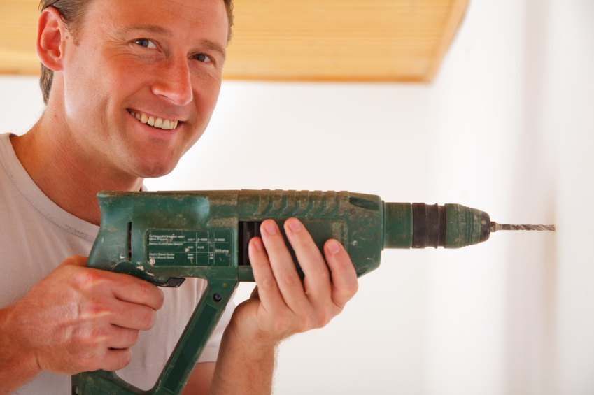 Photo of a man drilling with a power drill by nullplus/istockphoto.com.
