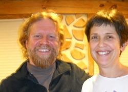 Todd Muller and Patty Smythe in front of a cordwood wall.  Photo: Cris Carl.
