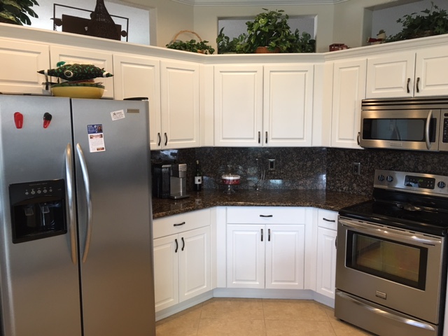 After: White painted cabinets brighten the whole kitchen After: White painted cabinets brighten the whole kitchen