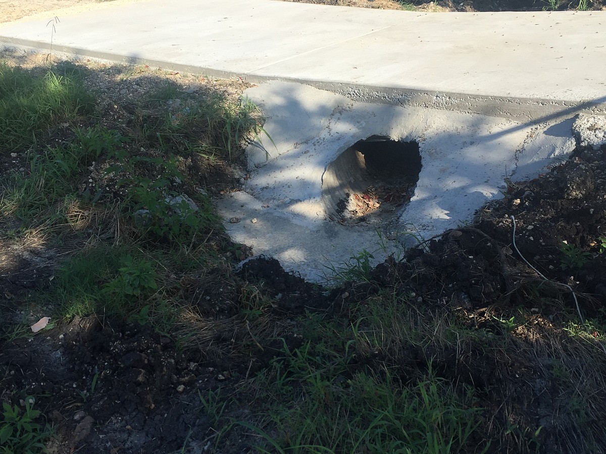 Concrete driveway over drainage pipe